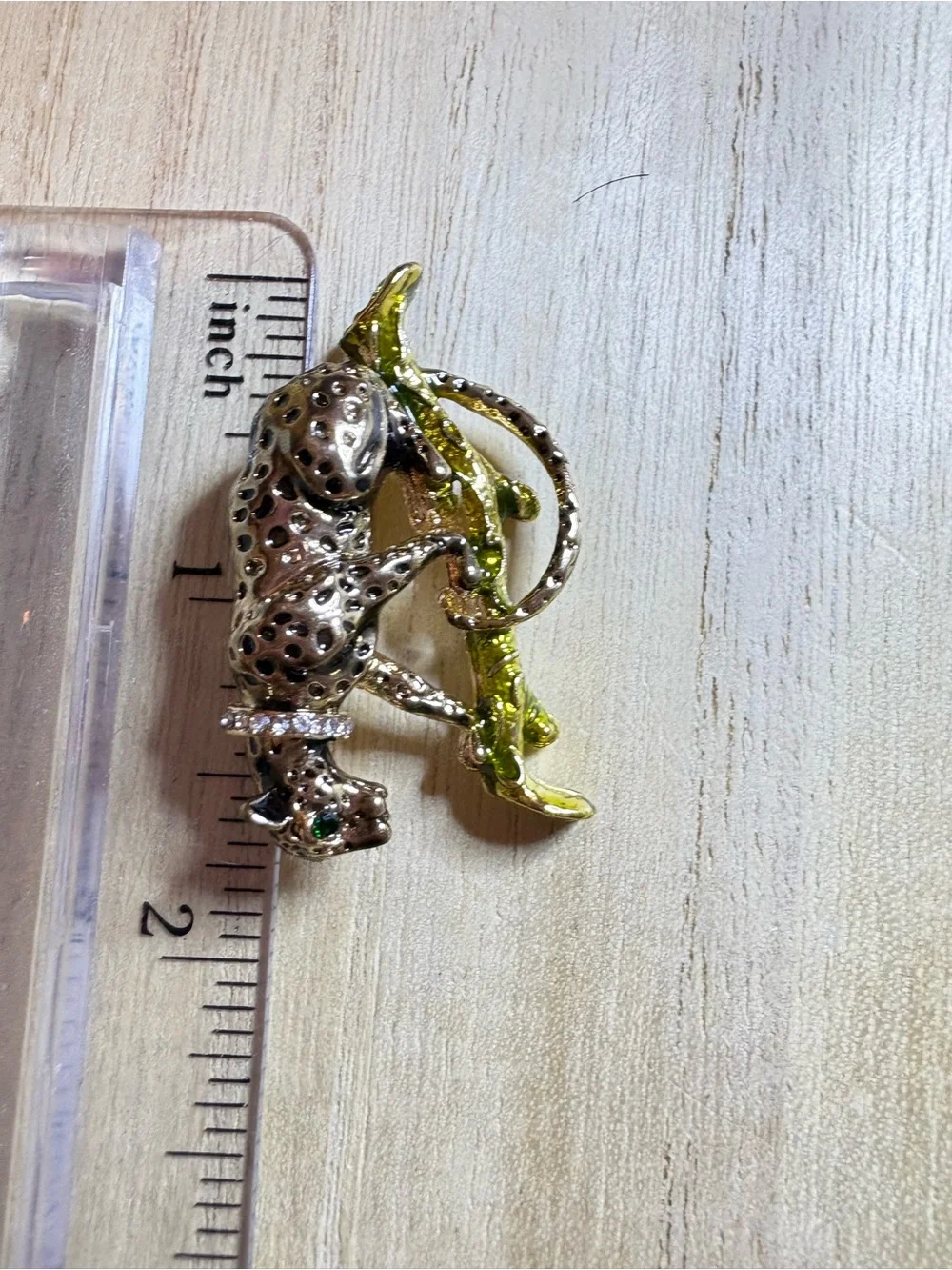 Gold-Tone Leopard Brooch with Green Accent on Branch